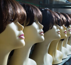 Mannequins,with,brunet,style,wigs,on,shelves,of,hair,salon